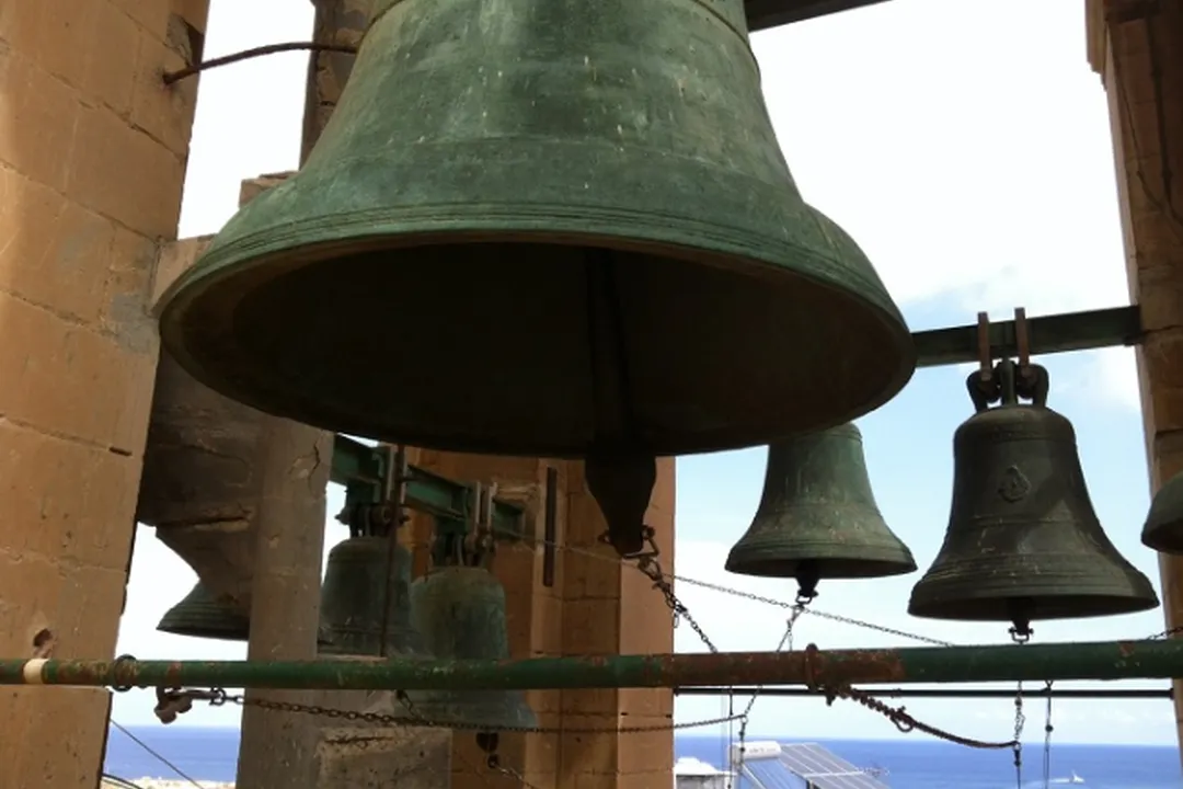 Reference photograph: Church bells against the sky, beside the paper model rebuilt from it
